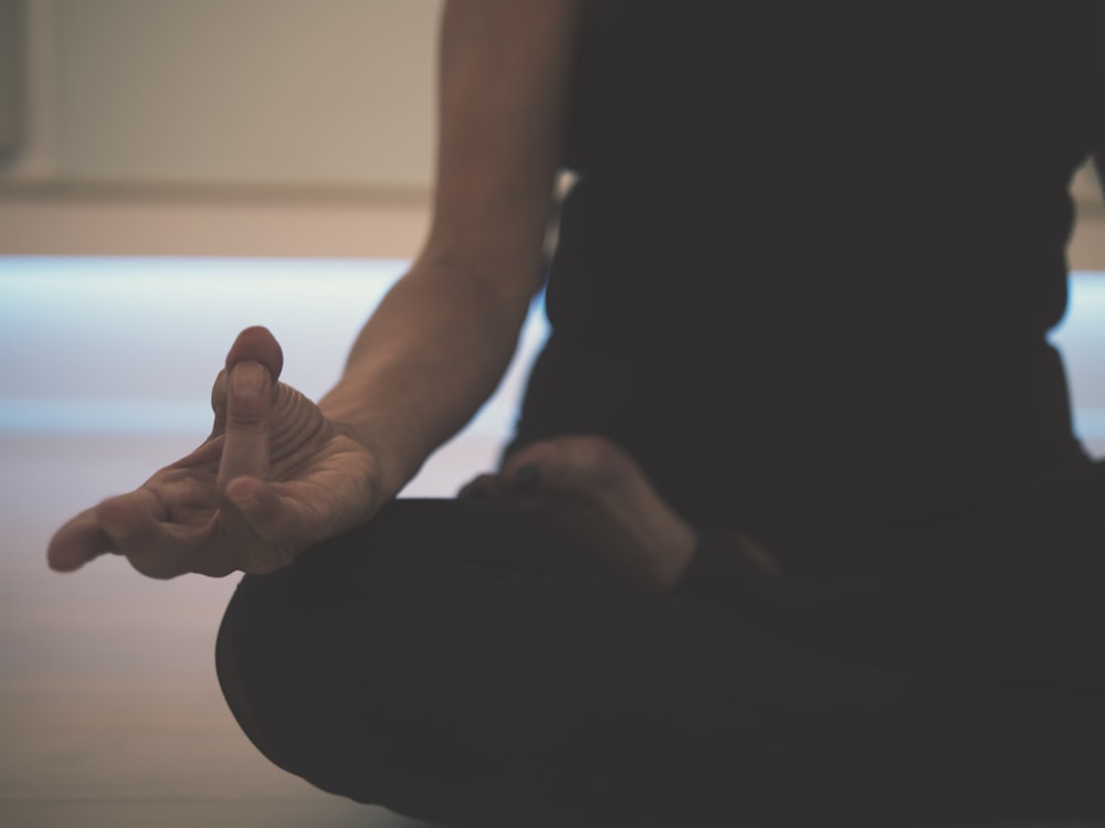 A close view of hands resting in a meditation mudra